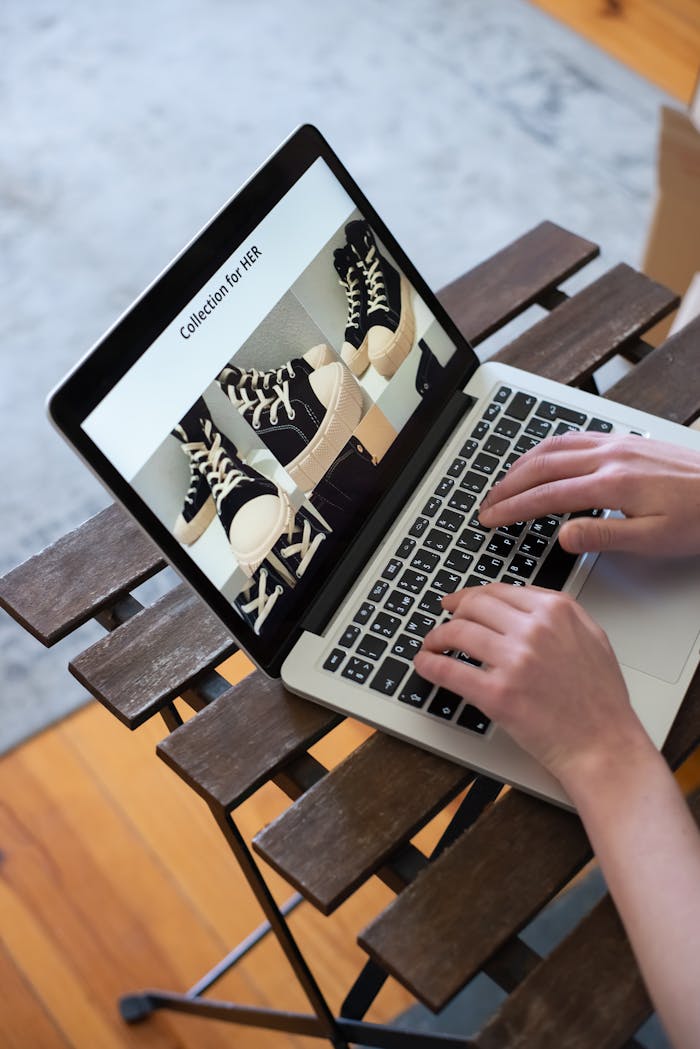 White-Label WordPress Development Services for Agencies | UNLIMITED WORDPRESS Hands browsing sneakers on laptop, showcasing online store shopping experience.